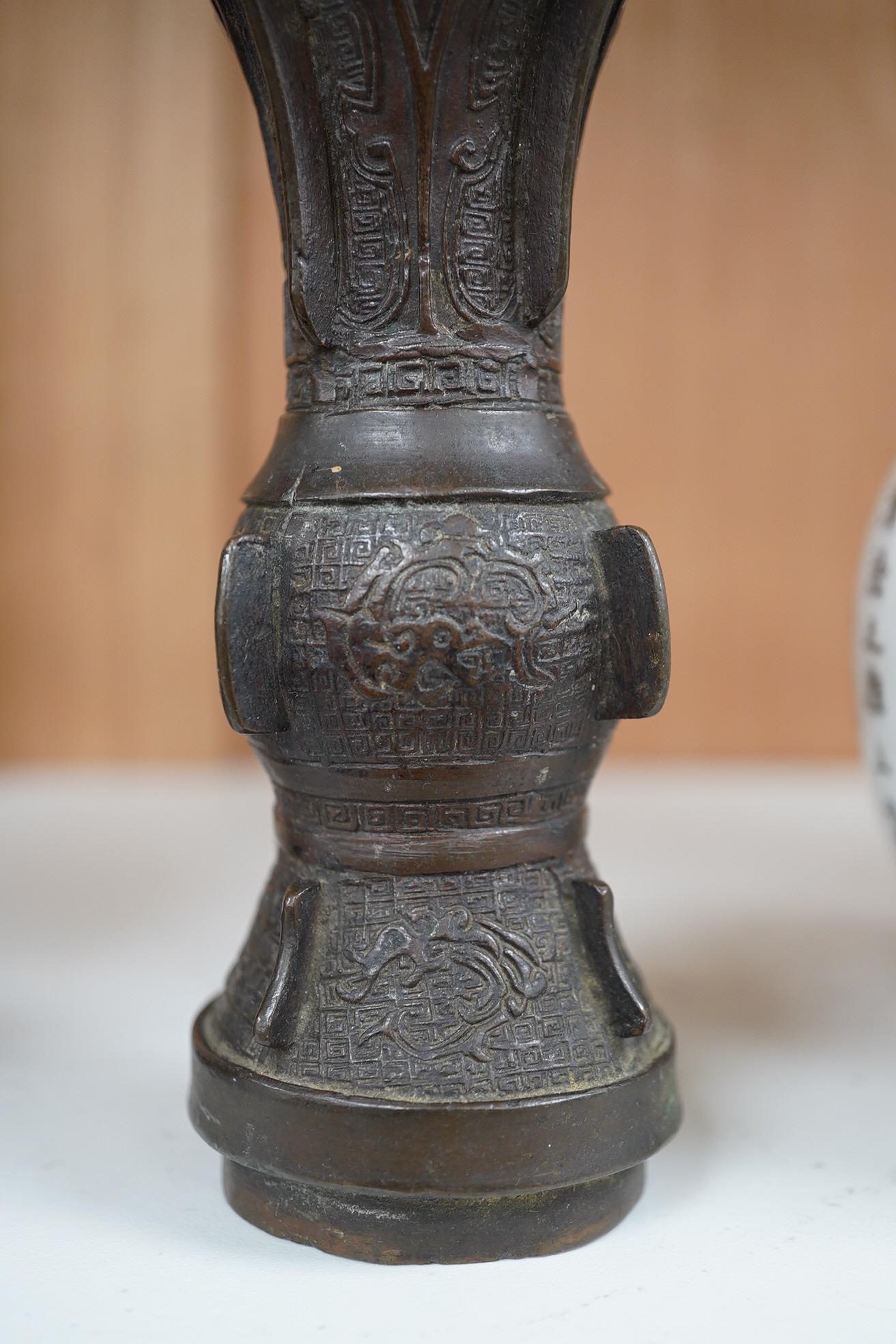 A pair 17th/18th century Chinese archaistic bronze gu vases, and a similar square vase, fanggu, Ming dynasty, tallest 18cm. Condition - poor to fair